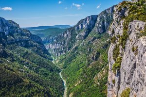 Blick in die grüne Verdonschlucht mit steilen Felswänden und Flusslauf